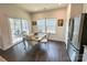 Bright dining area with hardwood floors, a patio door, and stainless steel refrigerator at 5047 Summer Surprise Ln, Charlotte, NC 28215