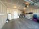 Clean and spacious garage with ample storage shelves and concrete floor at 5047 Summer Surprise Ln, Charlotte, NC 28215