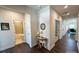 Bright hallway featuring hardwood floors, neutral walls, and access to a bathroom and office at 5047 Summer Surprise Ln, Charlotte, NC 28215