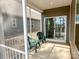 Relaxing screened porch with green chairs and view of the home's backyard at 5047 Summer Surprise Ln, Charlotte, NC 28215