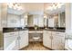 Double vanity bathroom with granite countertops and large mirrors at 573 Church St, Locust, NC 28097