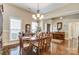 Formal dining room showcasing hardwood floors and elegant chandelier at 573 Church St, Locust, NC 28097