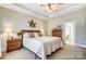 Spacious main bedroom with ceiling fan and large windows at 573 Church St, Locust, NC 28097