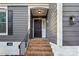 Front entrance with brick steps and black door at 603 Canadice Rd, Huntersville, NC 28078