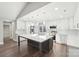 Modern kitchen features white cabinets, large island, and herringbone backsplash at 603 Canadice Rd, Huntersville, NC 28078