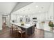 Modern kitchen with white cabinets, large island, and herringbone backsplash at 603 Canadice Rd, Huntersville, NC 28078