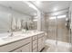 Modern bathroom featuring a double vanity, large mirror, and a glass-enclosed shower with neutral tile at 608 Cassidy Ct, Clover, SC 29710