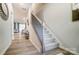 Hallway with carpeted stairs and a view of the open concept living and dining areas at 608 Cassidy Ct, Clover, SC 29710