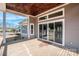 Covered back porch with wood ceiling and flooring, overlooking the backyard through sliding glass doors and windows at 6098 Ballard Rd, Denver, NC 28037