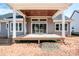 Rear facade of the home featuring the outdoor porch with a stained ceiling and seamless access to the yard at 6098 Ballard Rd, Denver, NC 28037