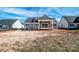 The spacious backyard with a home that features a covered patio, gray siding, and a dark gray roof at 6098 Ballard Rd, Denver, NC 28037