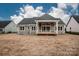 Back exterior view showcasing the deck and the expansive backyard at 6098 Ballard Rd, Denver, NC 28037