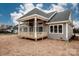 Back exterior view showcasing the deck and the expansive backyard at 6098 Ballard Rd, Denver, NC 28037