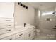 Elegant bathroom features single vanity with marble countertop, white cabinetry and a bathtub/shower combo at 6098 Ballard Rd, Denver, NC 28037