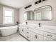 Bright bathroom featuring double vanity, modern fixtures and free-standing tub at 6098 Ballard Rd, Denver, NC 28037