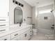 Bright bathroom featuring tub/shower, white cabinets, and modern fixtures at 6098 Ballard Rd, Denver, NC 28037