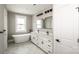 Bright bathroom featuring double vanity, modern fixtures and free-standing tub at 6098 Ballard Rd, Denver, NC 28037