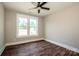 Cozy bedroom with hardwood flooring, ceiling fan, and a window offering natural light at 6098 Ballard Rd, Denver, NC 28037