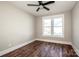 Cozy bedroom with hardwood floors, ceiling fan, and a window for natural lighting at 6098 Ballard Rd, Denver, NC 28037