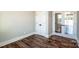 Bright bedroom with neutral walls, wood floor, and double doors and closet at 6098 Ballard Rd, Denver, NC 28037