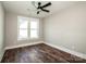 Small bedroom with hardwood floors, ceiling fan, and a window for natural lighting at 6098 Ballard Rd, Denver, NC 28037