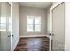 Bright bedroom with neutral walls, wood floor, and glass paneled doors to the hall at 6098 Ballard Rd, Denver, NC 28037