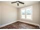 Bedroom featuring hardwood flooring, ceiling fan, and a large window for natural lighting at 6098 Ballard Rd, Denver, NC 28037