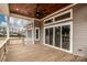 View of the home's wooden deck with ceiling fan and sliding glass doors at 6098 Ballard Rd, Denver, NC 28037