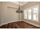 Dining room features hardwood floors, large windows, and a pendant light at 6098 Ballard Rd, Denver, NC 28037