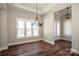 Dining area featuring hardwood floors, a stylish chandelier, and windows with outside views at 6098 Ballard Rd, Denver, NC 28037