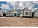 Charming gray home with white trim, double-door entry, stone accents, and attached two-car garage at 6098 Ballard Rd, Denver, NC 28037