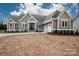 Charming gray home with white trim, double-door entry, stone accents, and attached two-car garage at 6098 Ballard Rd, Denver, NC 28037