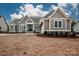 Charming gray home with white trim, double-door entry, stone accents, and attached two-car garage at 6098 Ballard Rd, Denver, NC 28037