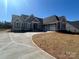 Attractive one-story home featuring an attached garage, neutral siding, and a long concrete driveway at 6098 Ballard Rd, Denver, NC 28037