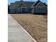 Exterior view of single-story home with neutral siding, dark roof, and attached garage at 6098 Ballard Rd, Denver, NC 28037