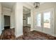 Elegant foyer featuring dark wood floors, a pendant light, and a view through the home's open layout at 6098 Ballard Rd, Denver, NC 28037