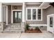 Attractive gray home featuring stone-accented front steps leading to a covered entrance at 6098 Ballard Rd, Denver, NC 28037