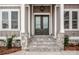 Charming home entrance featuring stone accents, a double door, and an elegant hanging light fixture at 6098 Ballard Rd, Denver, NC 28037