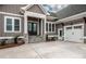 Attractive gray home featuring a double garage and stone-accented front steps leading to a covered entrance at 6098 Ballard Rd, Denver, NC 28037