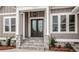 Beautiful front entrance with stone steps, a black double door, and a stylish hanging light fixture at 6098 Ballard Rd, Denver, NC 28037