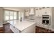 This bright kitchen features stainless appliances, white cabinets, and island countertop space at 6098 Ballard Rd, Denver, NC 28037