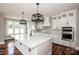 Gorgeous kitchen featuring a center island, modern appliances, sleek countertops, and hardwood floors at 6098 Ballard Rd, Denver, NC 28037