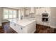 This bright kitchen features stainless appliances, white cabinets, and island countertop space at 6098 Ballard Rd, Denver, NC 28037