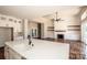 The bright kitchen flows to the great room with open floor plan, fireplace and ceiling fan at 6098 Ballard Rd, Denver, NC 28037