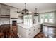 Kitchen island view showcasing an open floorplan with a fireplace and natural light at 6098 Ballard Rd, Denver, NC 28037