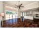 Open-concept living space with hardwood floors connecting to a modern, all-white kitchen at 6098 Ballard Rd, Denver, NC 28037