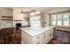 View of the living room fireplace and built-in shelving seen from the kitchen island at 6098 Ballard Rd, Denver, NC 28037