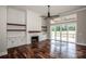 Bright living room featuring a fireplace, built-in shelving, hardwood floors, and access to an outdoor deck at 6098 Ballard Rd, Denver, NC 28037