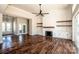 Bright living room with fireplace, custom shelving, hardwood floors, and sliding door access at 6098 Ballard Rd, Denver, NC 28037