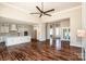 Open-concept living space with hardwood floors connecting to a modern, all-white kitchen at 6098 Ballard Rd, Denver, NC 28037